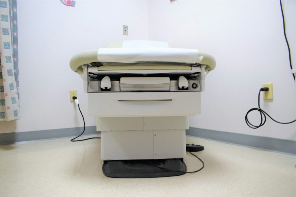 a hospital room with a bed and a charger