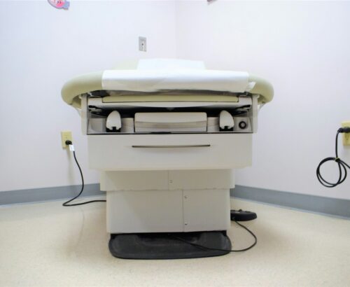 a hospital room with a bed and a charger