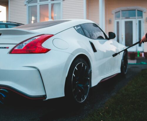 white porsche 911 parked near white house